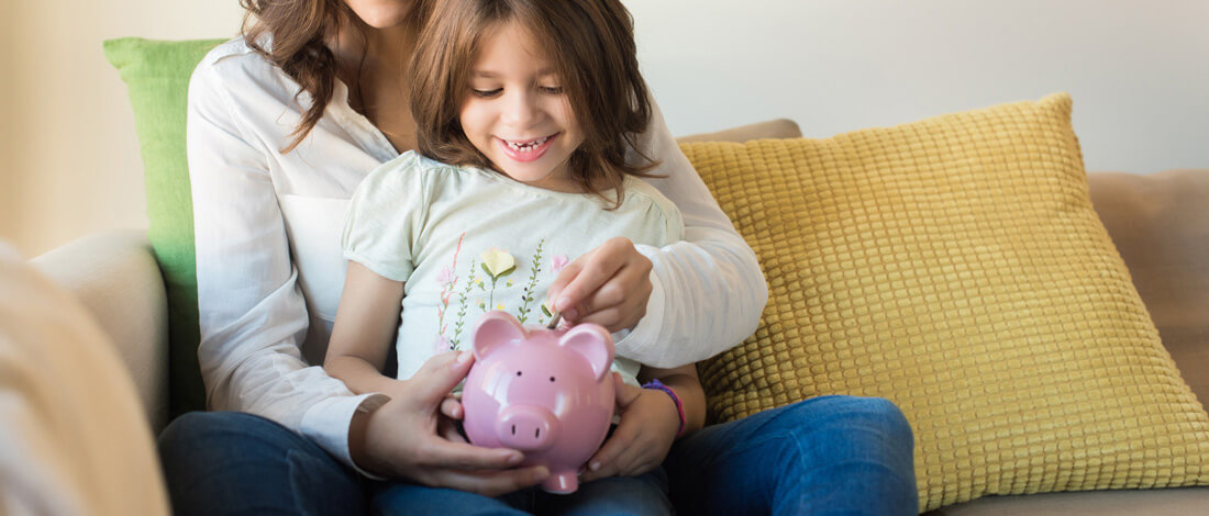 young girl with piggy bank